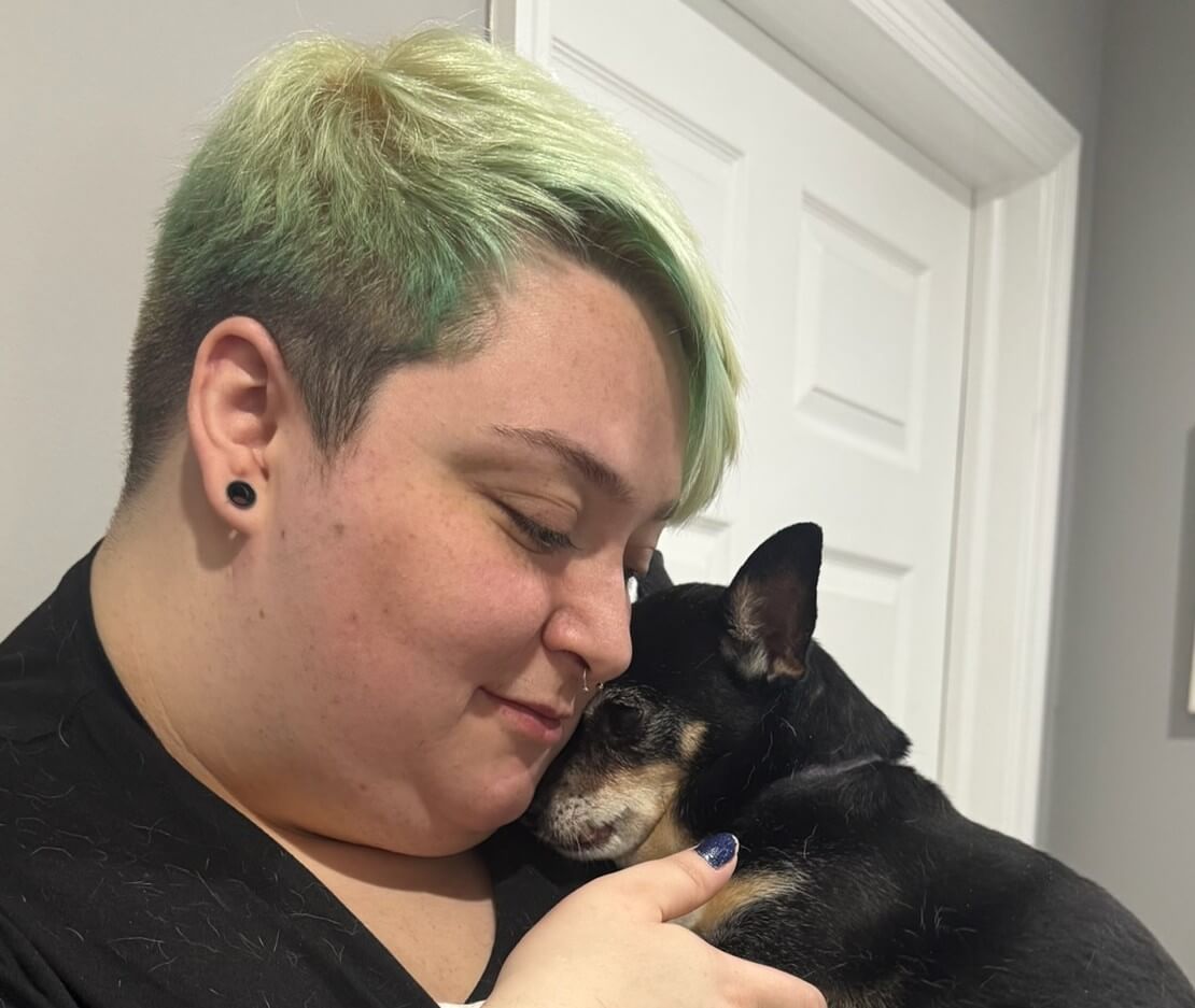 Some one cuddling a dog